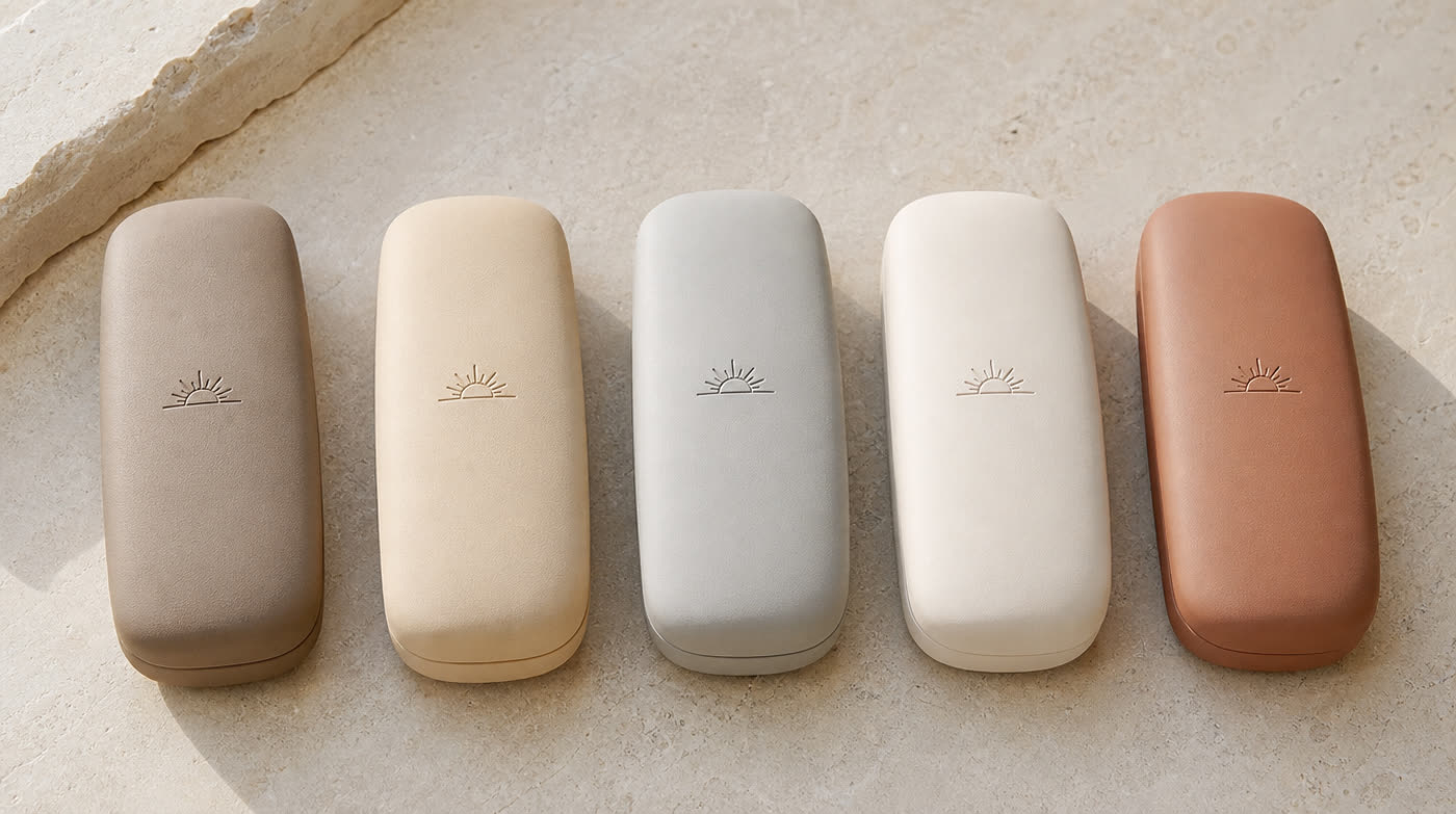 Five eyewear cases in different sand and stone tones